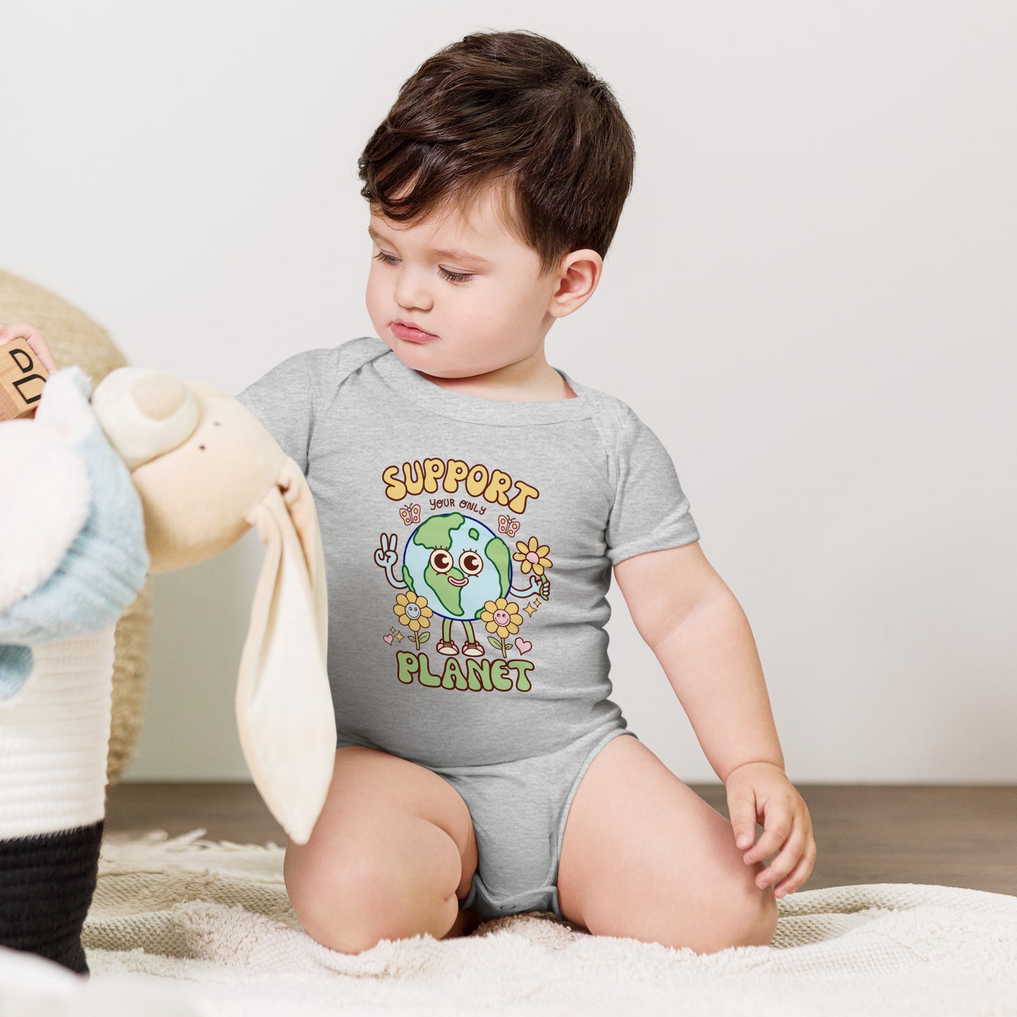 Original illustrated Earth character on a soft baby one piece for eco-minded families