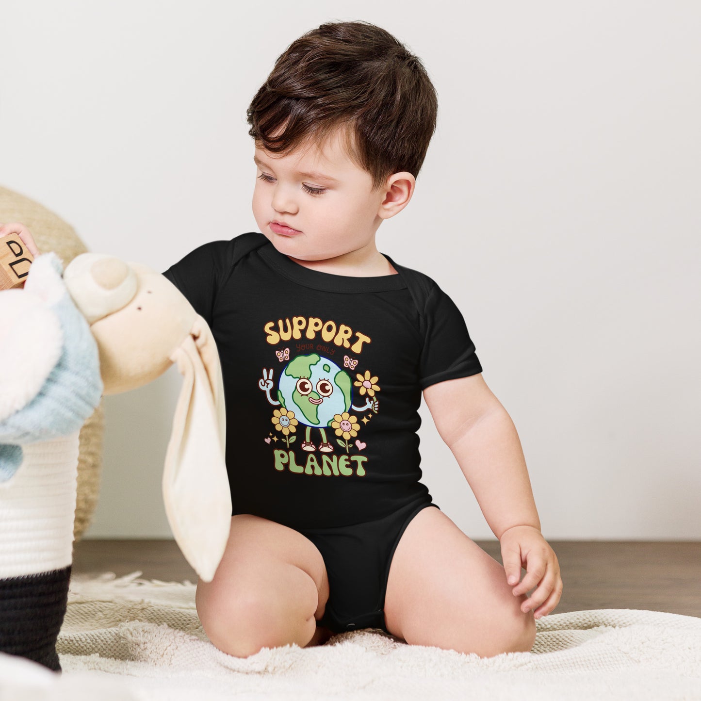 Hand-drawn eco baby one piece with a friendly cartoon planet for little Earth lovers