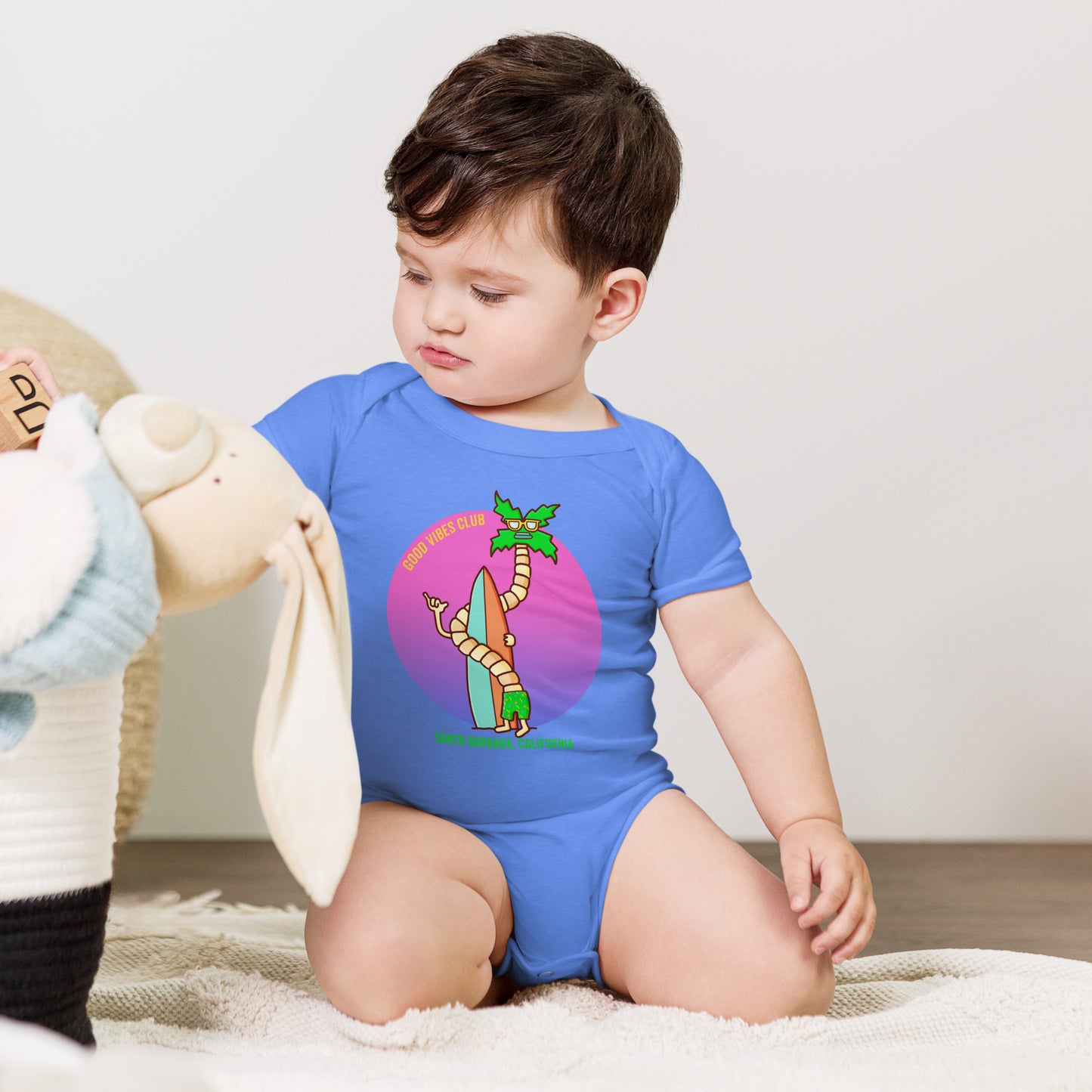 Hand-drawn palm and surf artwork on a soft California baby bodysuit