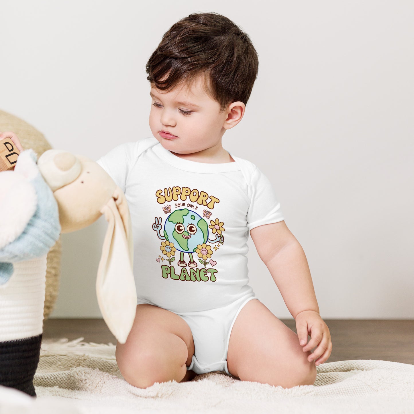 Colourful Earth Day artwork on a baby one piece by illustrator Daniel Sulzberg